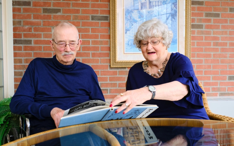 Marietta College Alumni Carl '64 and Judy '66 sit and look at an old yearbook together